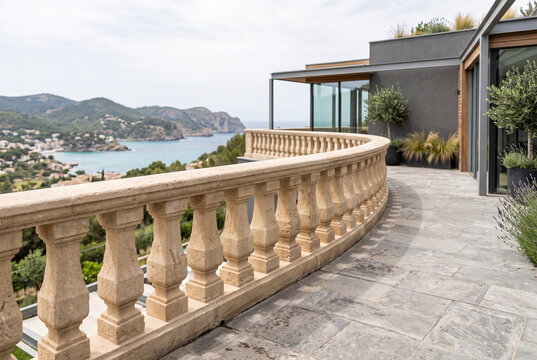 Stone balustrade railing on outdoor terrace of contemporary building
