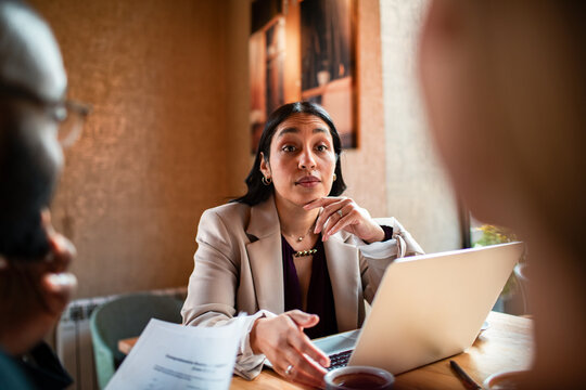 Female consultant leading client meeting at cafe