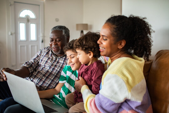 Multigenerational family using laptop together at home