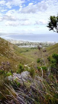 Mountain valley vista in Fernkloof toward Vo&euml;lklip Hermanus coastline. Vertical