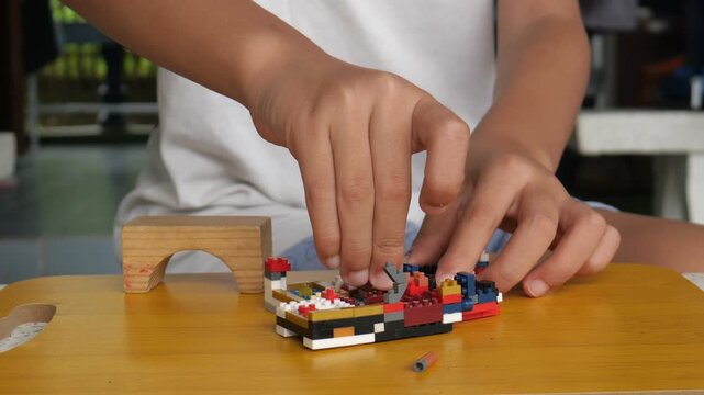 Children hands play with colorful blocks	