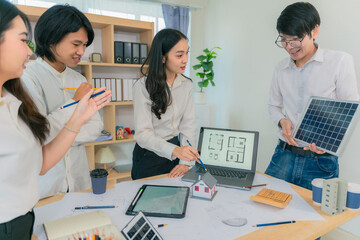 Fototapeta premium Diverse Architectural Team Collaborating on Sustainable Solar House Design and Construction Blueprints