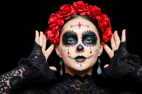 Halloween beauty portrait of woman. Beautiful female face adorned with Santa Muerte makeup.