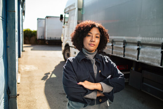 Confident female truck driver in logistics yard