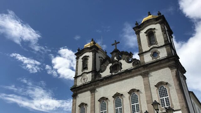 Majestic baroque architecture of the famous Nosso Senhor do Bonfim Church against a beautiful blue sky with white clouds, a major catholic pilgrimage site and tourist attraction in Salvador