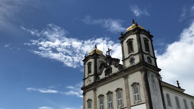 Stunning low-angle shot revealing the famous baroque facade of the Church of Nosso Senhor do Bonfim, a significant catholic pilgrimage site and landmark in Salvador da Bahia, Brazil