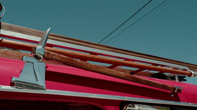 Chrome axe and wooden ladder mounted on the side of a red fire truck