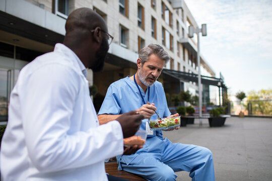Two doctors on lunch break outside hospital
