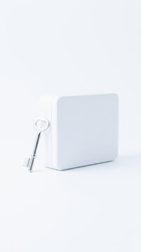 White lockbox with key represents healthcare insurance security and privacy in minimalist studio setting