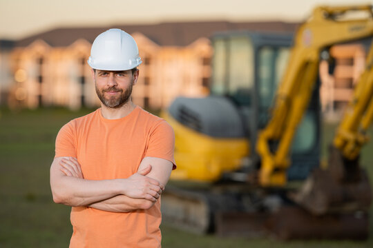 Builder in a construction site. Builder with excavator ready to build new house. Construction builder wear building uniform on excavation truck digging, builder with buildings construction background.