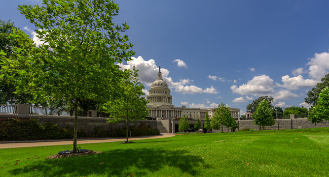 Washington DC federal landmark. United States Capitol architecture. Congress building in the capital. American government house. Flag waving at Capitol Hill. Famous Washington DC monument.