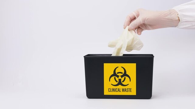 Serious black clinical medical waste disposal bin box container with yellow biohazard symbol showing hazard caution for healthcare safety