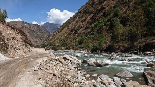 Footage while walking nearby the Langtang Khola river a river coming from the south flows down along the Langtang trekking route, Nepal. 