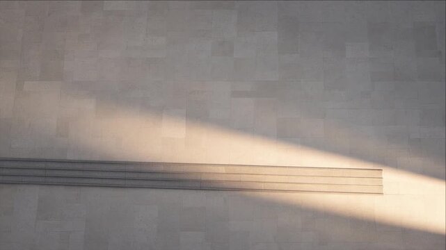 Cinematic minimal timelapse sunlight crossing textured concrete wall, architectural background with warm light, shadow, horizontal line, calm abstract texture composition