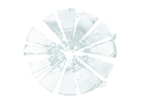 Isolated pieces of shattered circular glass arranged in a radial pattern on a white background transparent background