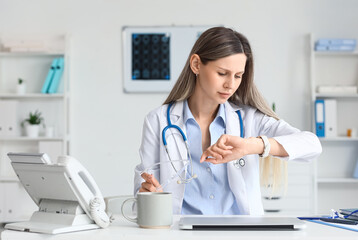 Healthcare professional time management and busy schedule, female doctor checking watch in modern...