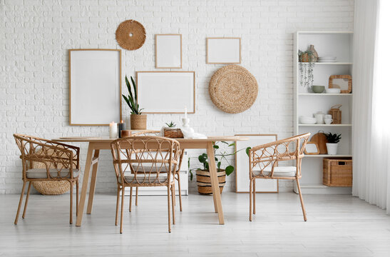 Boho chic dining room interior design, modern home decor with natural materials and empty frames on white brick wall