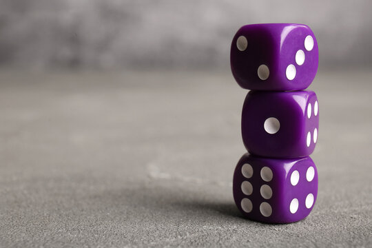 Purple dices on grey background
