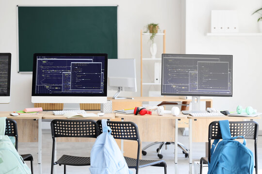 Desks with computer monitors in school computer lab