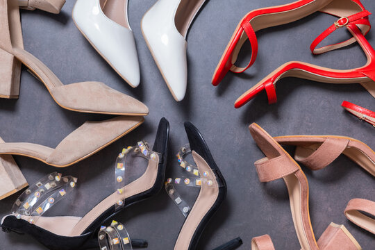 Group of different heels arranged on dark surface