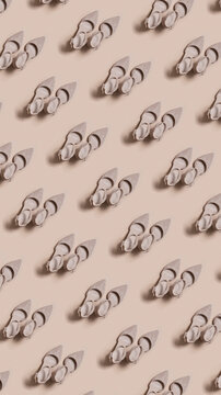 Pattern of shoes displayed on a light background in a repeated design showing a unique shape and style