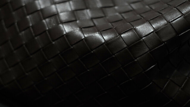 premium black leather with geometric woven pattern and elegant tonal gradations