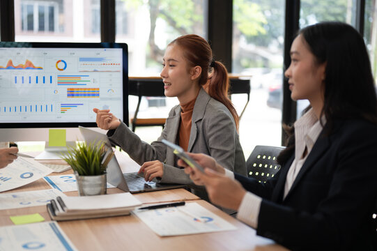 Business meeting with women discussing data analytics and strategy in modern office