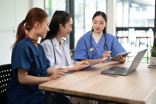 Healthcare professionals discussing patient care and reviewing medical information together