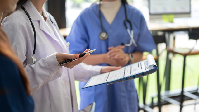 Healthcare professionals reviewing medical information on laptop and tablet together