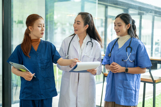Doctors and nurses discussing medical records and patient care at a healthcare meeting