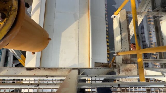 An industrial tanker fills from a high‑pressure overhead pipe at a refilling bay near EGA in Dubai&rsquo;s logistics zone.