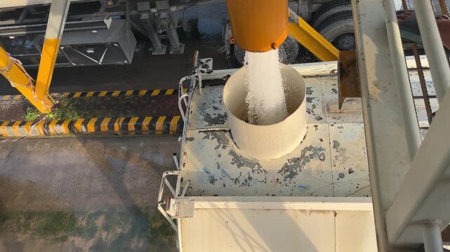 An industrial tanker fills from a high‑pressure overhead pipe at a refilling bay near EGA in Dubai&rsquo;s logistics zone.