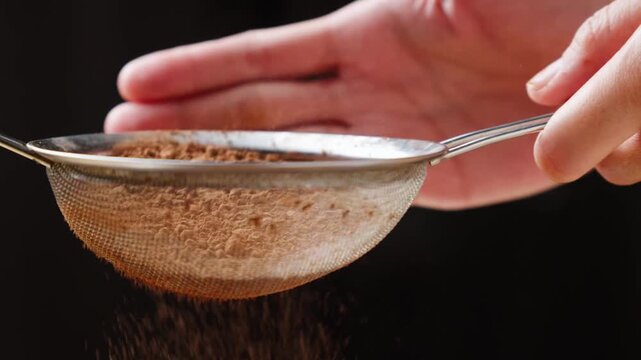 Sifting cocoa powder through a fine mesh strainer
