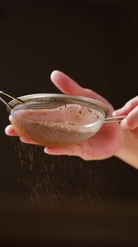Sifting cocoa powder through a fine mesh strainer