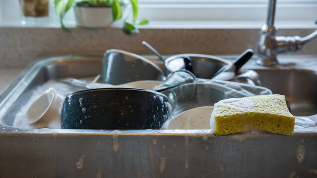 Soaking dirty dishes in kitchen sink