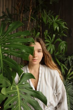 Woman with Long Hair Portrait Behind Tropical Palm Leaves
