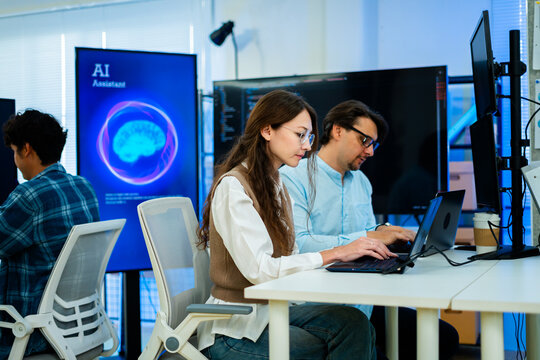 software developer talk strategy plan to executive write prompt AI bot IT app program data analytics in tech startup office.Projected visuals and glowing code on screen.AI chatbot technology concept
