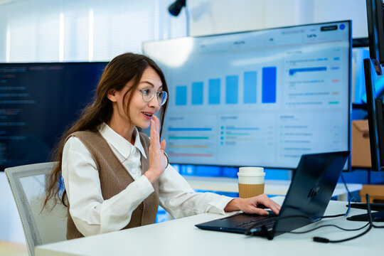 Successful and beautiful caucasian woman working at modern office building.businesswoman using laptop for video call smiling and waving,online conference with colleagues