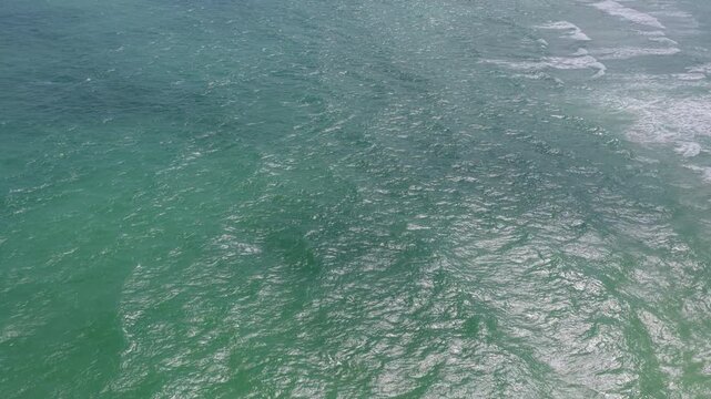 Ripple water of ocean. Aquamarine ocean nature. Background clear turquoise sea water. Idyllic summer vacation. Caribbean sea. Aerial view on rippled surface, 4k. Sea water surface