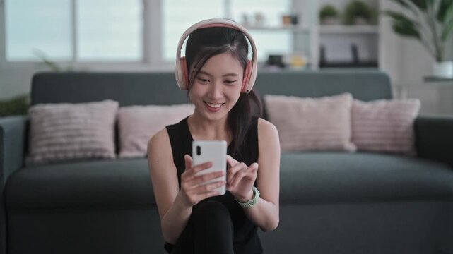 Asian fitness woman using phone for workout search online