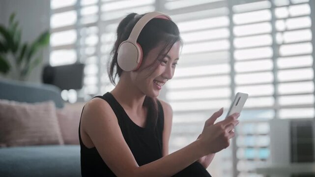 Asian fitness woman using phone for workout search online
