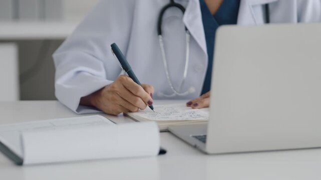 Doctor examines medical reports and patient data in clinic room
