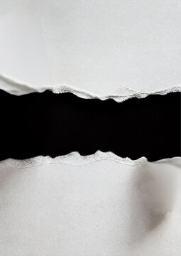 Two pieces of ripped white paper with a dark black gap in the middle for text space