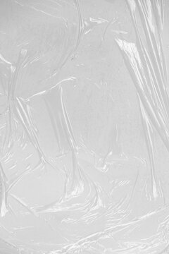 Crumpled plastic warp. Grunge plastic wrap on white background. Texture transparent stretched film polyethylene