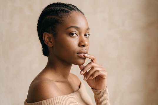 African American young woman touching lips in thoughtful portrait