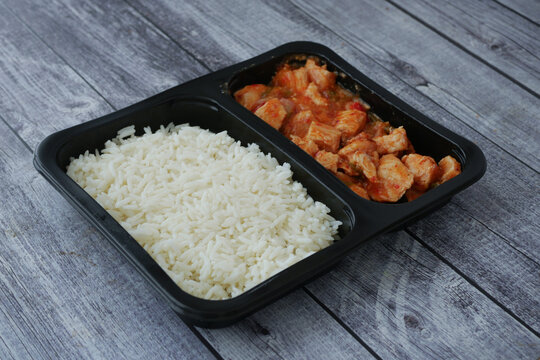 Chicken and rice meal in a black tray