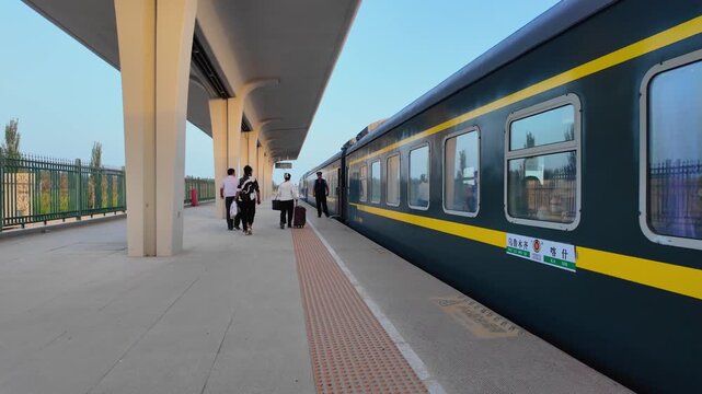 Hotan Railway Station at Night and Day with Green Passenger Trains