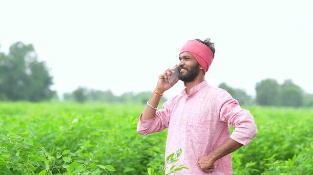 indian farmer talking on smartphone at split pigeon pea agriculture field