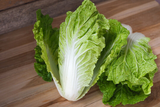 Fresh organic Chinese cabbage on a wooden background close-up.