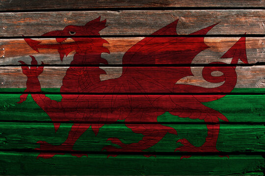 3D Flag of Wales on a old wood wall background.